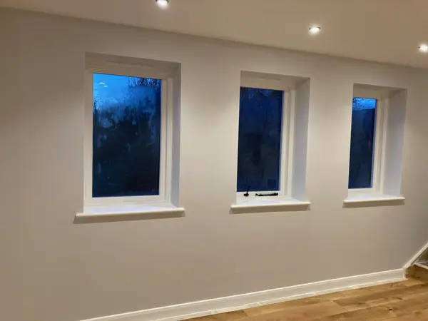 Freshly painted room with three windows and spotlights by SkimDecor in Worcester