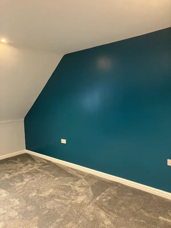 Deep teal feature wall in a decorated room by SkimDecor in Worcester
